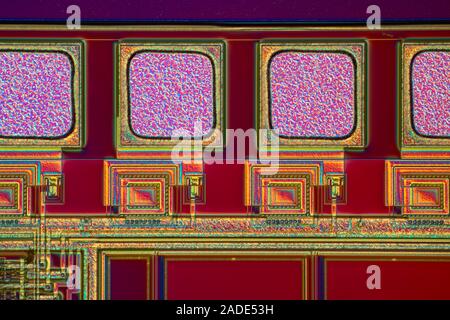 Microchip surface. Differential interference contrast (DIC) light micrograph of the surface of a silicon wafer etched with integrated circuits. Magnif Stock Photo