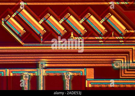 Microchip surface. Differential interference contrast (DIC) light micrograph of the surface of a silicon wafer etched with integrated circuits. Magnif Stock Photo
