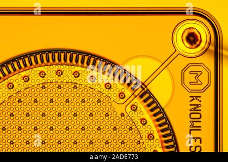 Knowles MEMS (MicroElectroMechanical System) microphone wafer. MEMS microphones are installed in nearly all modern smartphones. The image shows a deta Stock Photo