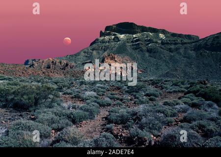 Composite image of the Moon during a partial lunar eclipse, placed over Mount Teide, Tenerife, Canary Islands Stock Photo