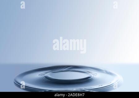 Circular ripples on liquid surface. Stock Photo