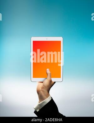 Businessman's hand holding digital tablet above cloud. Cloud storage concept. Stock Photo