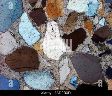 Sandstone compacted particles. Light micrograph of compacted rock forming sandstone. Sandstone is a type of sedimentary rock, one formed from the depo Stock Photo