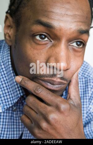 Young man looking thoughtful. Stock Photo