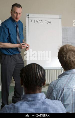 Probation Officer running a seminar for a group of offenders on probation. Stock Photo