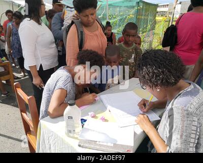 Suva, Fiji. 4th Dec, 2019. Residents register before receiving measles vaccine in Suva, Fiji, Dec. 4, 2019. The second phase of the measles immunization campaign began on Wednesday in Fiji's capital Suva. The immunization campaign targets children who have not received two doses of the measles vaccine, any child aged 12 and 18 months who is due for immunization, people travelling overseas, healthcare workers, and airport and hotel staff around the country. There are 15 confirmed measles cases in Fiji by Tuesday. Credit: Zhang Yongxing/Xinhua/Alamy Live News Stock Photo