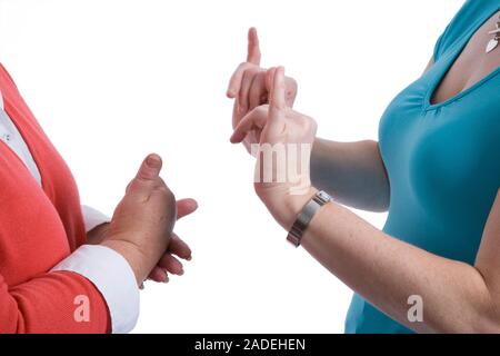 Two women using sign language to communicate. Stock Photo