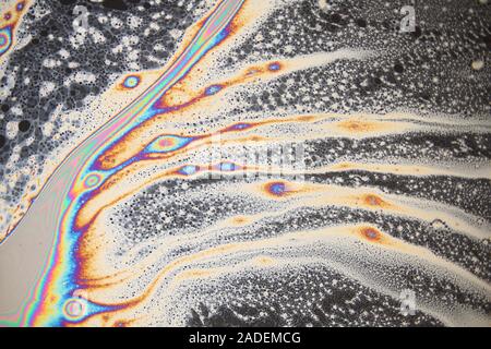 Soap bubble film iridescence, thin film interference. Iridescence is the property of certain surfaces to change colour depending on the angle of light Stock Photo