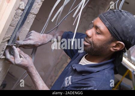 Electrician installing cables. Stock Photo