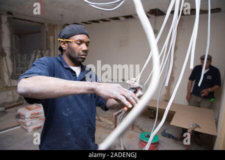 Electrician installing cables. Stock Photo