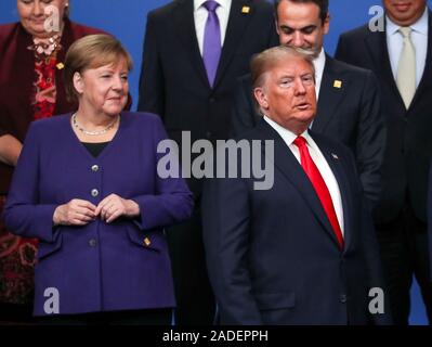 US President Donald Trump (right) and German chancellor Angela Merkel (left) during the annual Nato heads of government summit at The Grove hotel in Watford, Hertfordshire. Stock Photo