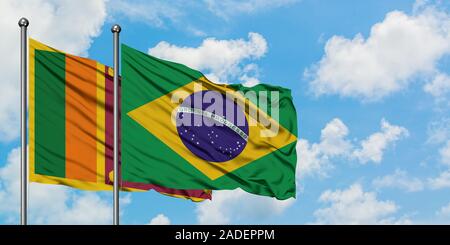 Brazil and Sri Lanka flag waving in the wind against white cloudy blue ...