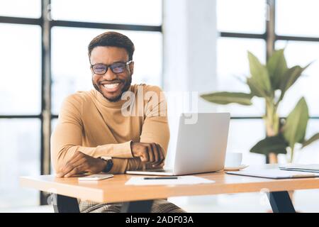 Happy african american guy looking at camera Stock Photo