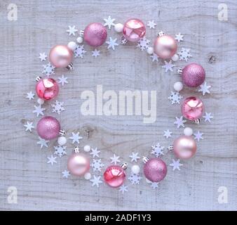 Christmas or new year composition. Round frame made of christmas decoration on wooden background. Holiday and celebration concept for postcard or invi Stock Photo