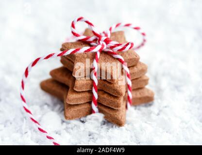 Christmas cookies - fresh baked star shaped biscuits on the snow. Stock Photo