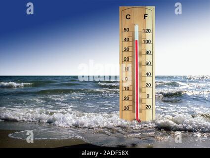 Global warming, conceptual image. Thermometer in sea indicating a high temperature. This could represent the rise in global temperature and sea levels Stock Photo