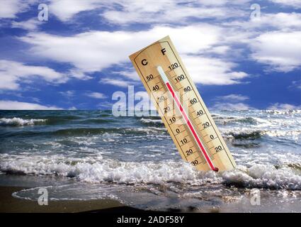 Global warming, conceptual image. Thermometer in sea indicating a high temperature. This could represent the rise in global temperature and sea levels Stock Photo