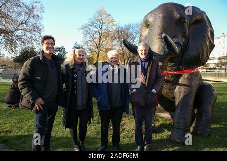 Marble Arch. London, UK 4 Dec 2019 - Artists Marc (L), Gillie (2nd from left), Author and father of the Prime Minister Boris Johnson, Stanley Johnson, (2nd from Right) and Parliamentary Conservative candidate for Richmond Park and North Kingston and former Tory candidate for Mayor of London Zac Goldsmith (R) pose with a bronze elephant during the unveiling of life-sized herd of 21 bronze elephants at Marble Arch. at Marble Arch. Credit: Dinendra Haria/Alamy Live News Stock Photo