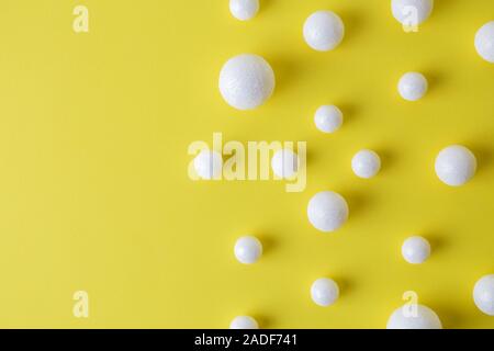 Bubbles made of styrofoam balls on yellow background minimal creative concept. Stock Photo
