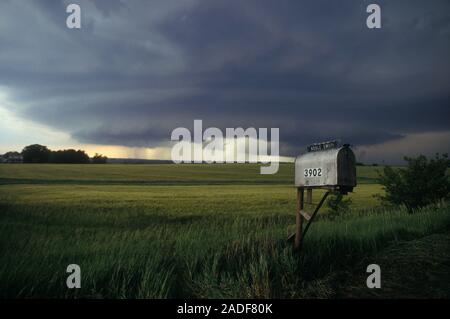 Mesocyclone thunderstorm moving over farmland. A mesocyclone is a rotating column of air found in the centre of extreme thunderstorms, known as superc Stock Photo