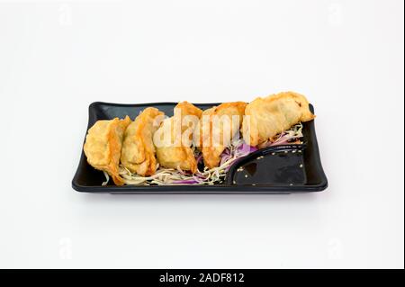 Deep fried pork Dumplings with soy sauce on ceramic plate Stock Photo