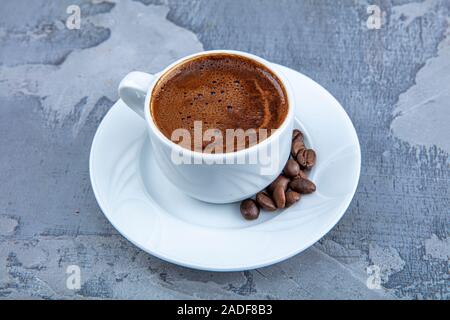 Delicious Turkish Coffee served with chocolate in traditional cup , close up shot. Stock Photo