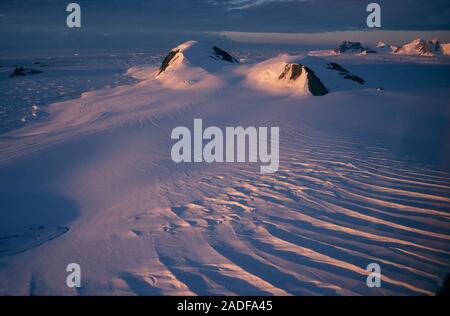 Antarctic midnight sun. Sunlight at midnight, during summer, over the Eureka Glacier that flows from the plateau of the Antarctic Peninsula into the s Stock Photo