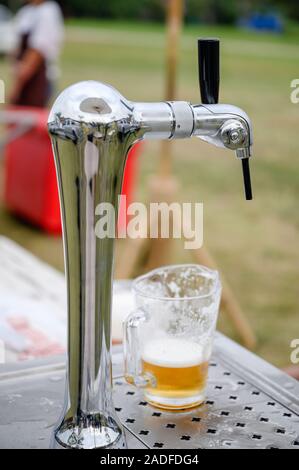Draft beer in mug on handle tap machine in the party Stock Photo