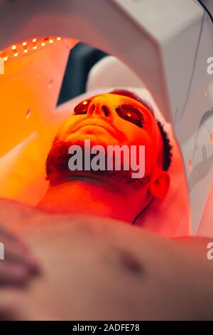 Bearded man in solarium looking glad and smiling Stock Photo