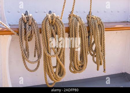 Ropes hanging on board of a big a sailing boat Stock Photo