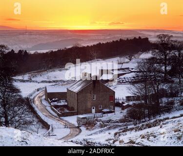 Rural winter landscape. Sunset seen from Hadrian's Wall over a snowy landscape. This is Walltown Farm in Northumberland National Park, England. Stock Photo