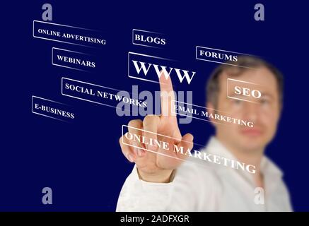 Businessman pressing business type of modern buttons with virtual background Stock Photo