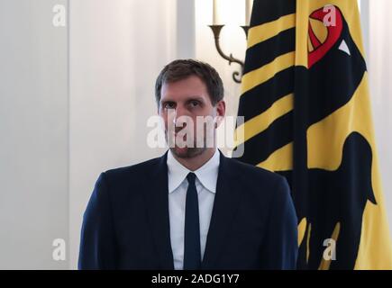 Berlin, Germany. 4th Dec, 2019. Former German basketball player Dirk Nowitzki reacts during a ceremony for the Order of Merit of the Federal Republic of Germany at the Bellevue Palace in Berlin, capital of Germany, on Dec. 4, 2019. Credit: Shan Yuqi/Xinhua/Alamy Live News Stock Photo