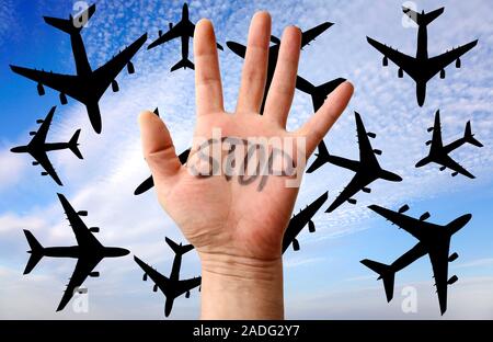 Environmental protest. Conceptual image showing a hand with 'STOP' written on it, and a background of aeroplanes. This represents people protesting on Stock Photo