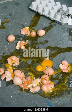 A Dozen Broken Eggs on a Sidewalk, USA Stock Photo