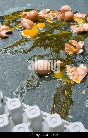 A Dozen Broken Eggs on a Sidewalk, USA Stock Photo