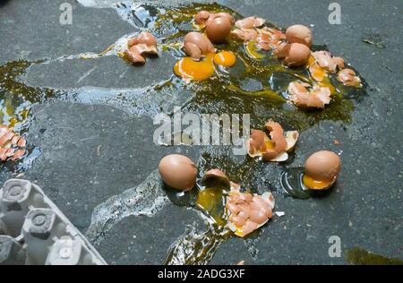 A Dozen Broken Eggs on a Sidewalk, USA Stock Photo