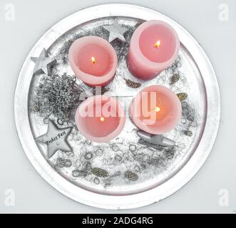 christmas candle decoration on plate with four burning candles fourth advent Stock Photo