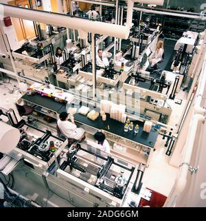 Genetic research. Technicians working in a laboratory. This lab works on mapping genomes. A genome is an organism's total genetic material. This genet Stock Photo