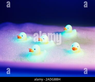 Rubber ducks in a foamy bath. Stock Photo