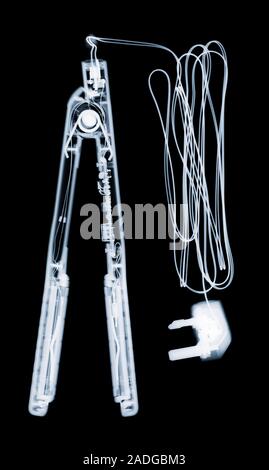 Hair straightners, coloured X-ray. Stock Photo