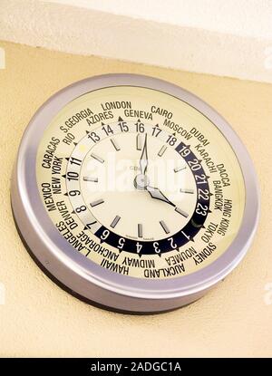 World clock. Clock displaying the local time in cities in different countries. Photographed in the United Nations Office at Geneva (UNOG), Switzerland Stock Photo