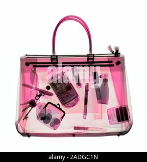 Handbag, coloured X-ray. Its contents include make-up, a purse, keys, pens and a mobile phone. Stock Photo