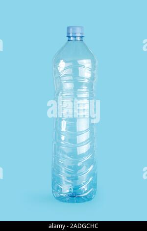 Empty plastic water bottle on a blue background Stock Photo