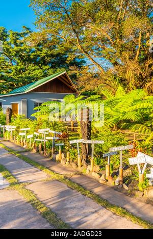 Wooden sculptures at the foot of the volcano Yasur, Tanna Island, Vanuatu. Vertical Stock Photo