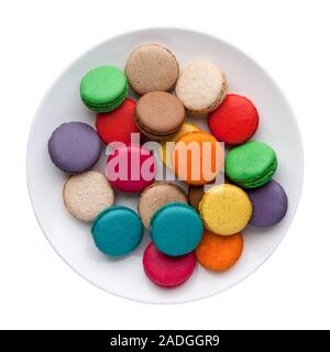 colorful macaroons in a plate on a white background. Top view. Isolated Stock Photo