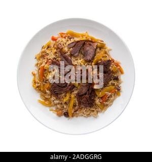 traditional pilaf with meat in a plate on a white background.  Top view. Isolated Stock Photo