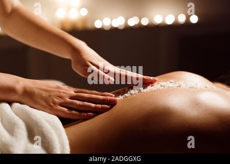 Spa concept. Woman receiving salt back massage Stock Photo