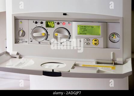 Household boiler controls. This is a gas boiler, which burns natural gas, heating water for use in the kitchen, bathroom and radiators. The on/off swi Stock Photo