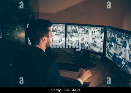 Profile side view portrait of nice serious web specialist supervising alarm panel night shift calling online information technical support 24.7 bank Stock Photo